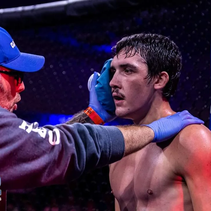 Ethan Riley receiving attention at ringside