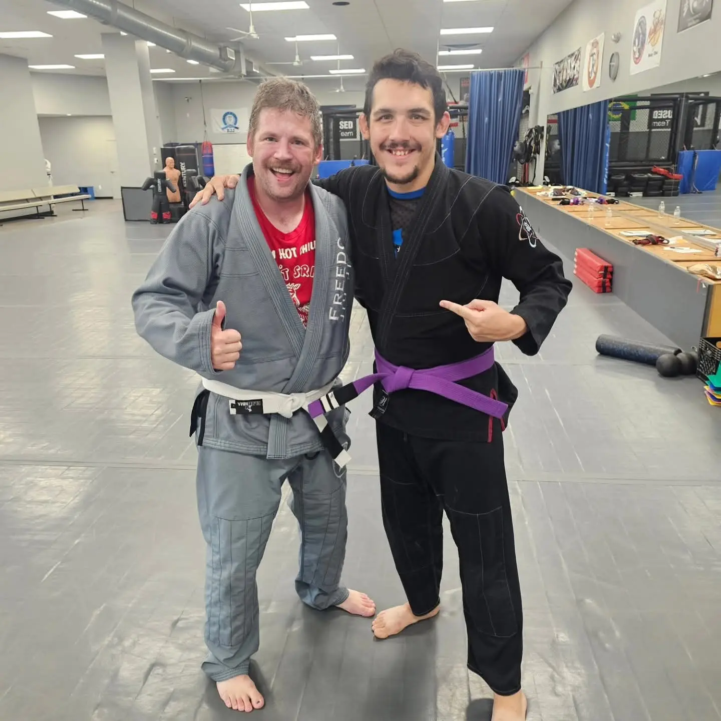 Ethan Riley in a black gi with a training partner on the mats at Club MMA