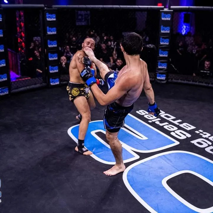 Ethan Riley delivering a kick during an MMA bout