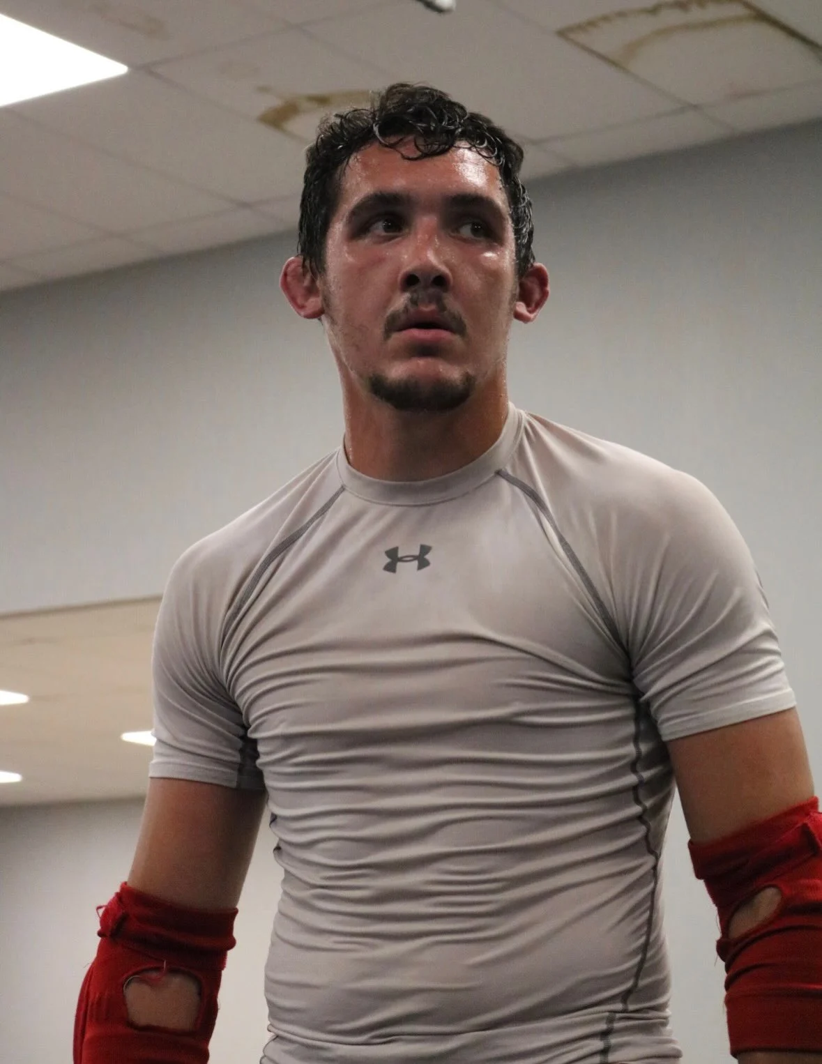 Ethan Riley in a gray training shirt and red elbow pads at Club MMA